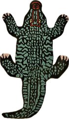 Hand tufted alligator-shaped rug with green, black, coral, and yellow accents, luxury home decor