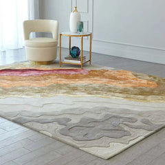 Abstract multicolor hand tufted rug with warm earth tones, paired with cream chair and gold side table in modern room