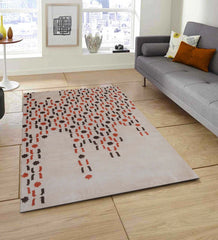 Modern geometric wool rug featuring burnt orange and brown motifs