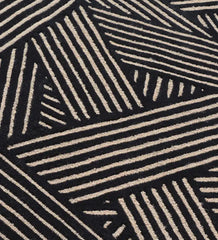 Modern black wool rug with beige linear weave pattern.