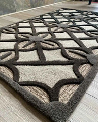Black lattice motif rug on beige background for living rooms.