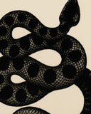 Artistic novelty area rug featuring black snake on beige base.