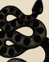 Artistic novelty area rug featuring black snake on beige base.