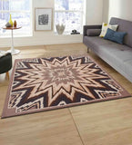 Beige and brown starburst geometric rug in modern living room with gray sofa and wooden floor