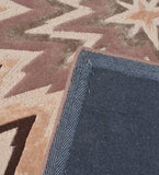 Beige and brown starburst geometric rug with blue textured fabric corner detail