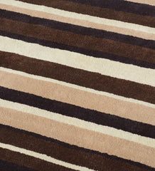 Modern hand-tufted area rug in beige, brown, and ivory tones.