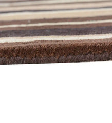 Hand-tufted wool rug with warm beige and brown linear pattern.