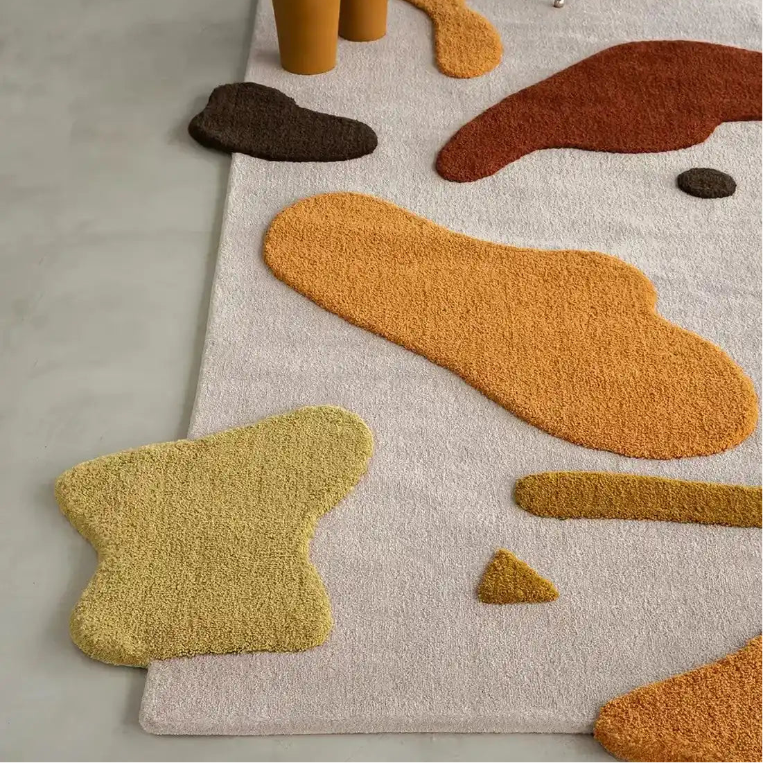 Handcrafted wool rug in earthy beige and mustard tones.