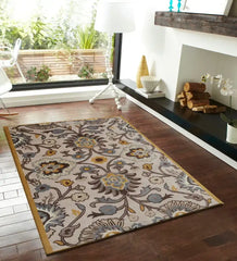 Beige hand-tufted wool rug with floral pattern in modern living room on wooden floor
