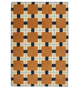 Hand-tufted wool rug with terracotta squares and navy grid design