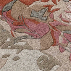 Close-up of beige and blush floral abstract handwoven rug with textured patterns and warm tones