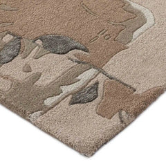 Close-up of beige and blush floral abstract handwoven luxury rug with textured design