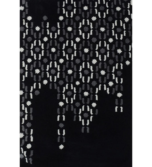 Abstract black hand-tufted wool rug with grey and white dot pattern