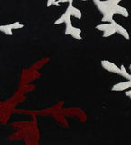 Black floral hand-tufted rug with red and white botanical patterns
