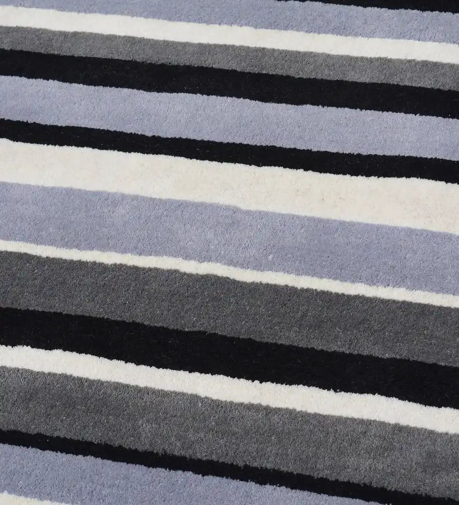 Hand-tufted wool area rug with modern monochrome stripe design.