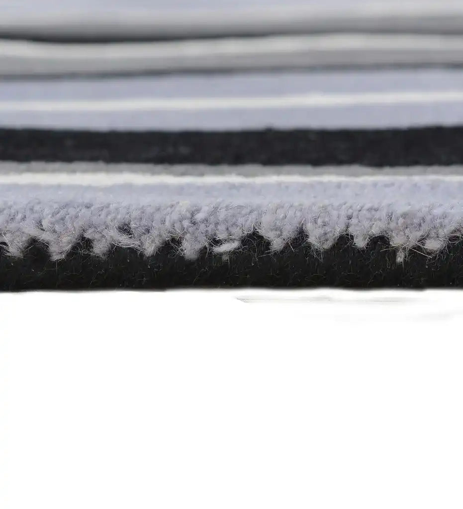 Contemporary striped wool rug in gray, white, and black tones.
