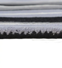 Contemporary striped wool rug in gray, white, and black tones.