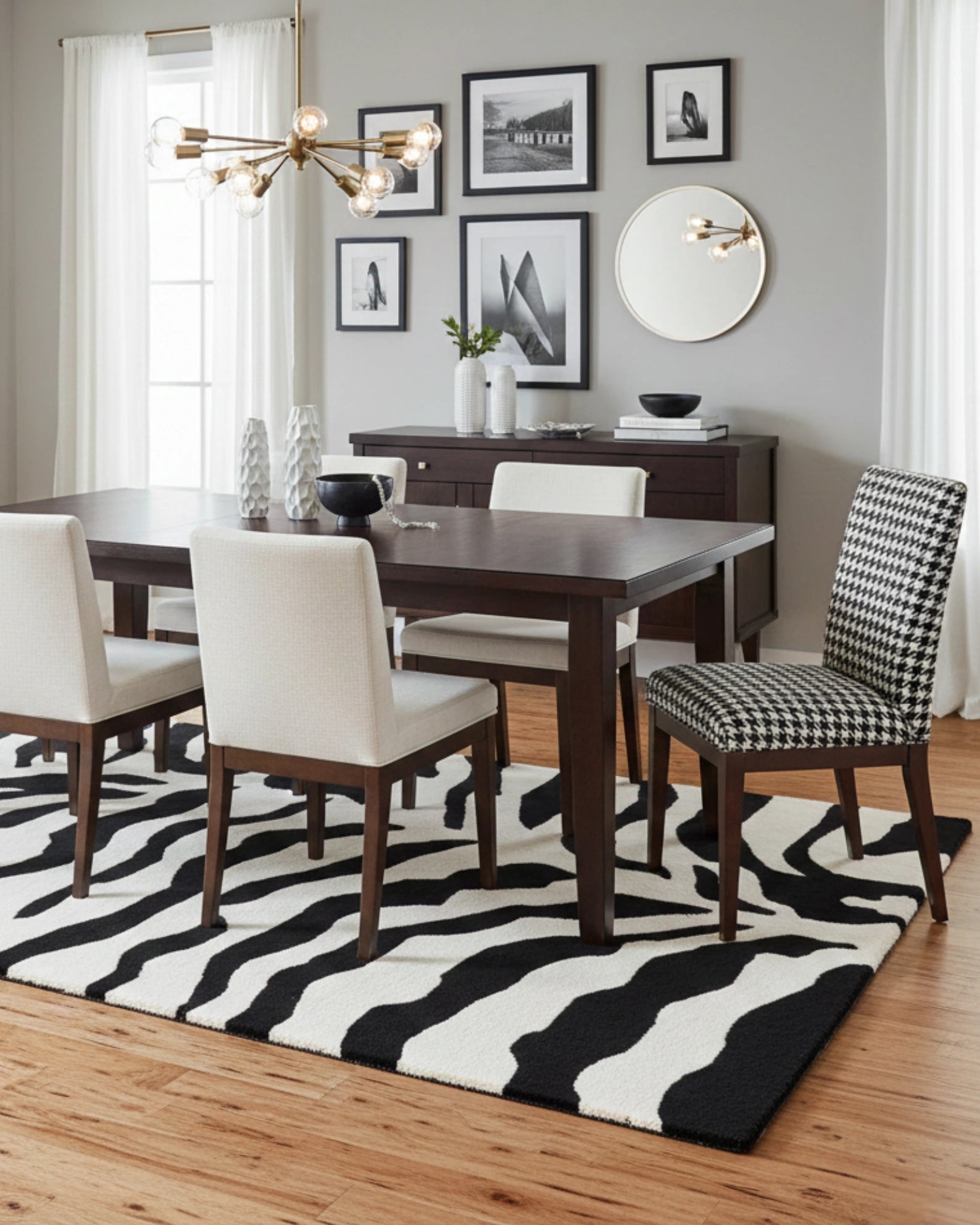 Black and ivory zebra pattern hand-tufted area rug styled in a dining room, adding a bold and modern statement