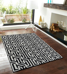 Modern monochrome artisan rug featuring maze-inspired design