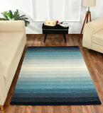 Modern artisan rug featuring teal, cream, and navy gradient