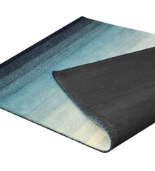 Hand-tufted blue rug transitioning from teal to navy tones