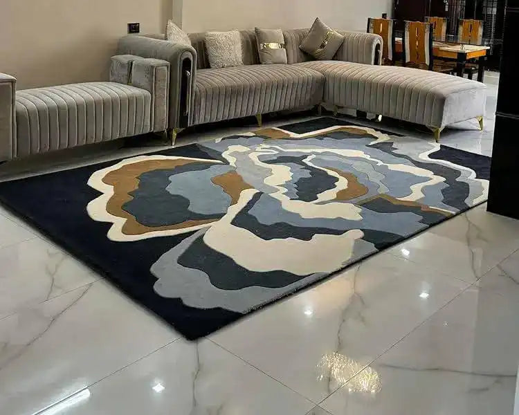 Blue modern abstract rug in a living room with grey sectional sofa and marble tile floor