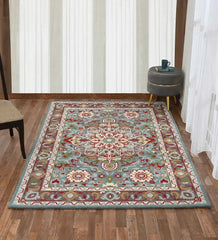 Blue traditional hand tufted wool carpet with floral patterns on wooden floor in modern room