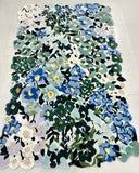 Handwoven luxury floral rug with blue, green, and white wild meadow design on tiled floor