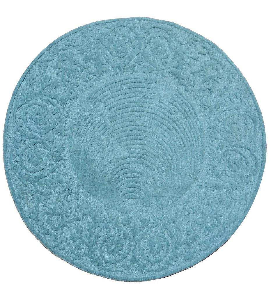 Round blue hand tuftet traditional wool rug with intricate embossed floral and spiral patterns