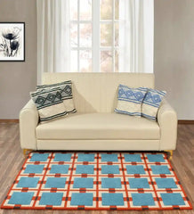 Blue and red retro geometric grid rug in a modern living room with beige sofa and window