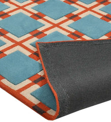 Blue and red retro geometric rug with intersecting grid pattern, corner flipped up