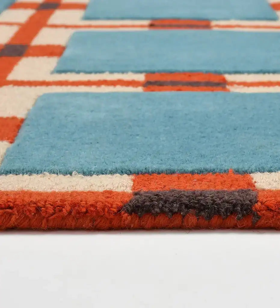 Blue and red retro geometric grid rug with thick textured wool pattern