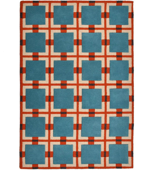 Hand-tufted wool rug with retro geometric grid pattern in teal blue, rust red, and ivory.