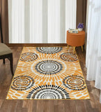Boho sunburst rug with orange and black circular patterns on wooden floor in a bright room with white curtains