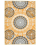 Boho sunburst rug with circular black and mustard yellow patterns on white background