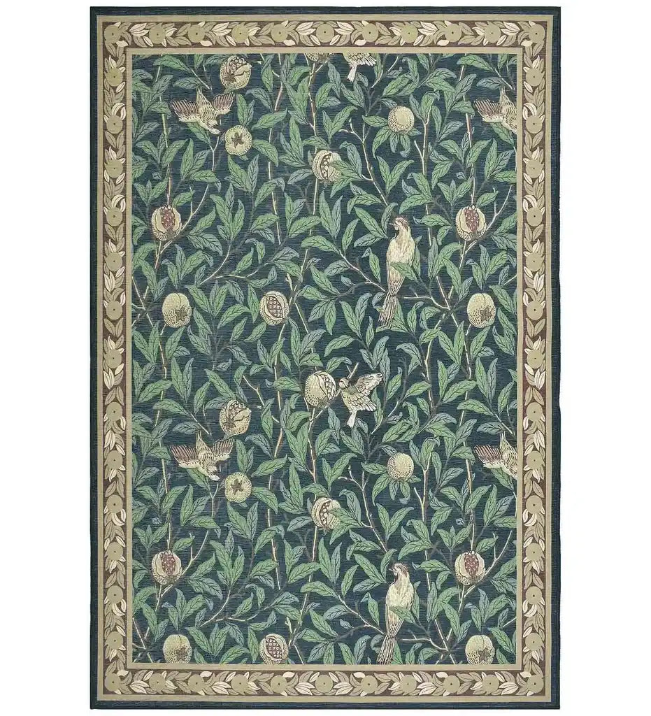 Luxury botanical rug with green leaves, pomegranate fruits, and birds on deep blue background, decorative border