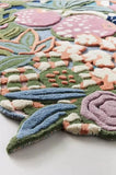Colorful floral rug with pink flowers and green leaves on a white background