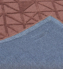 Minimalist embossed wool rug in earthy brown tones