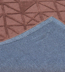 Minimalist embossed wool rug in earthy brown tones