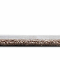 Minimalist hand-tufted rug with artistic stripe layering.