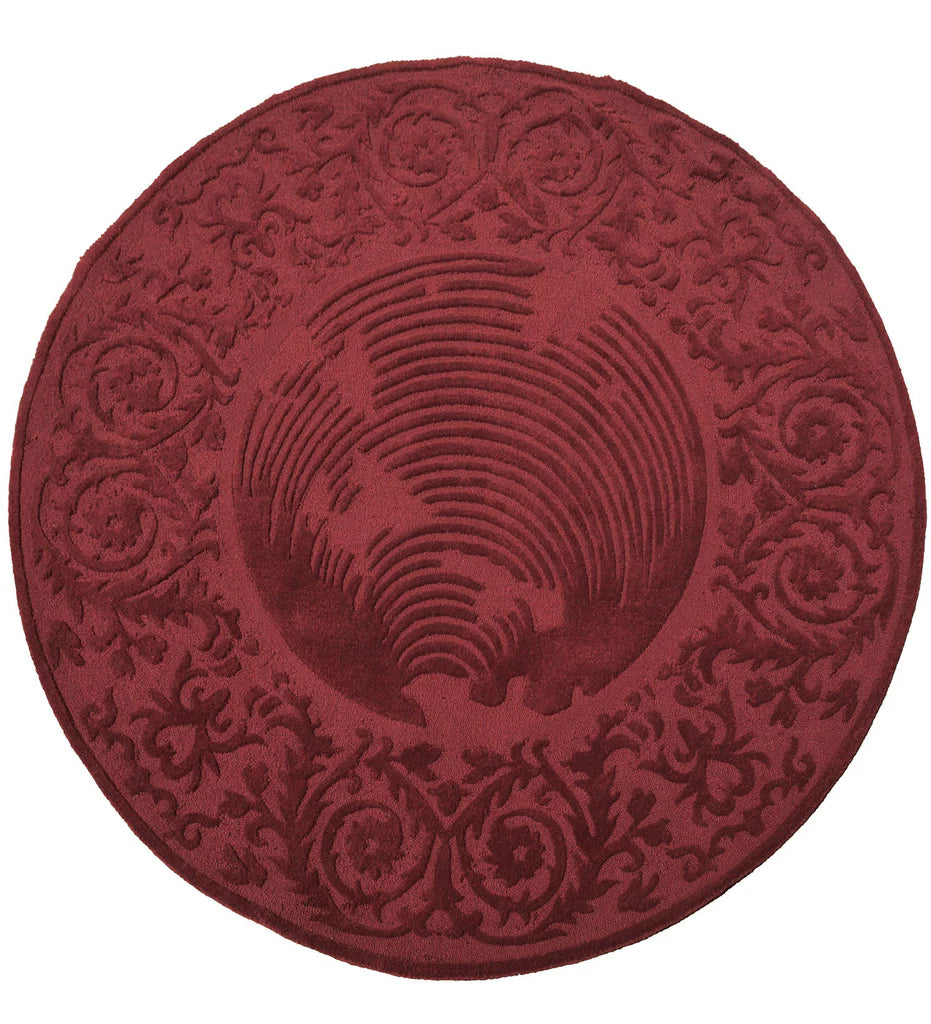 Round burgundy hand-tufted wool rug with embossed floral design