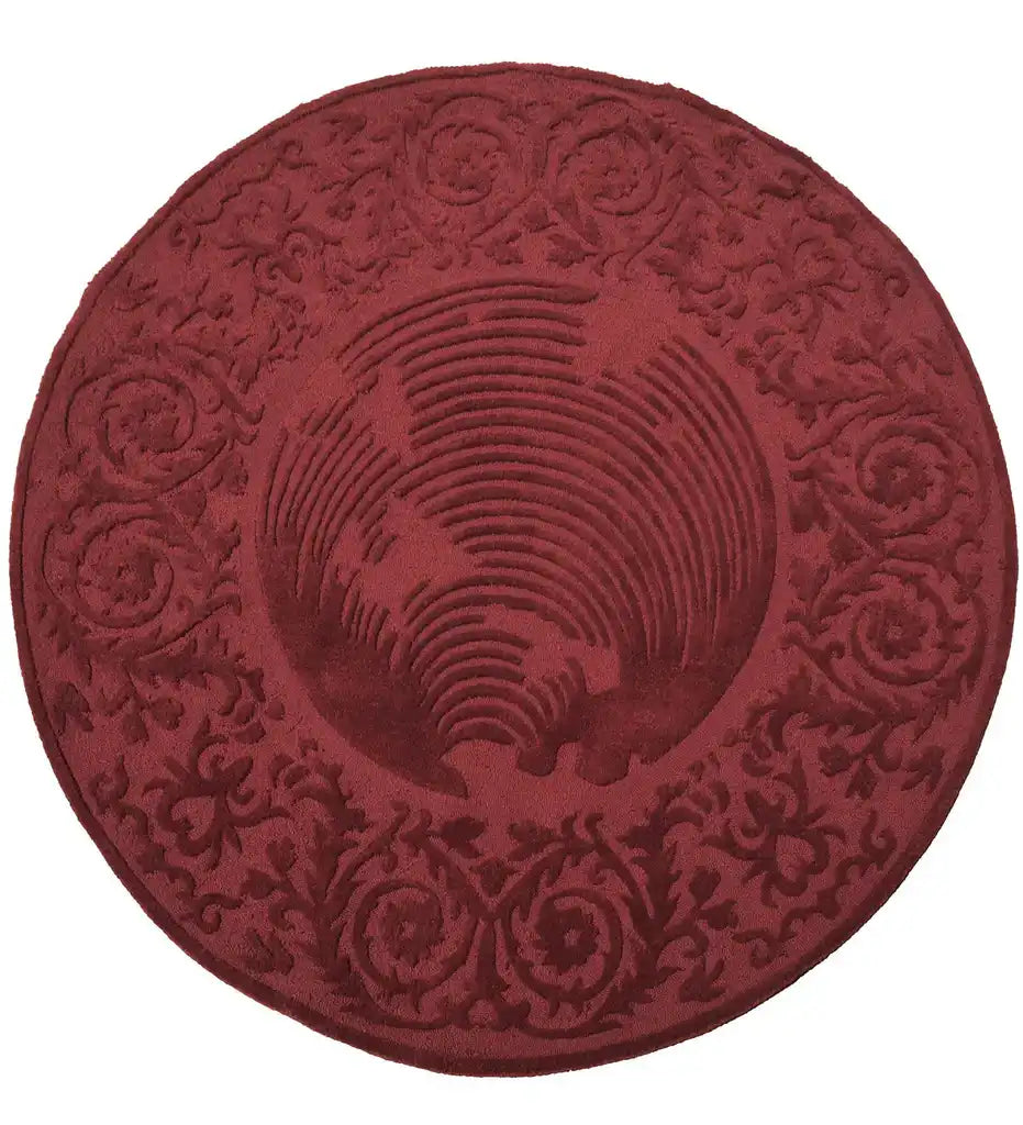 Round burgundy traditional rug with ornate scroll and floral embossed patterns