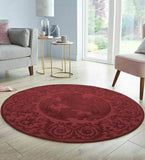 Burgundy round traditional ornate rug on light wooden floor in modern living room