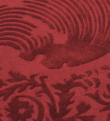 Traditional round red rug with embossed ornate border