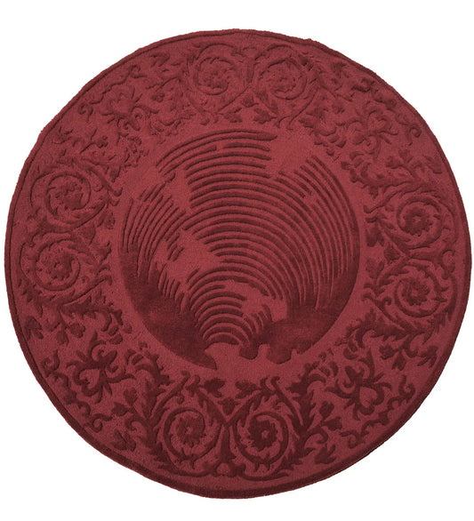 Round burgundy hand-tufted wool rug with embossed floral design