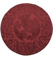 Round burgundy traditional rug with ornate scroll and floral embossed patterns
