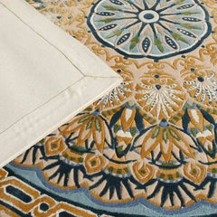 Close-up of Celestia hand-tufted luxury rug with intricate floral and geometric patterns in beige, blue, and green