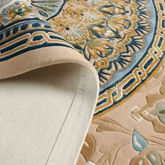 Close-up of Celestia hand-tufted luxury rug with intricate blue, gold, and beige floral pattern