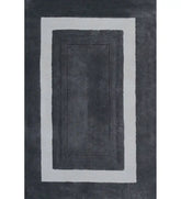Charcoal grey bordered hand-tufted wool rug with ivory frame