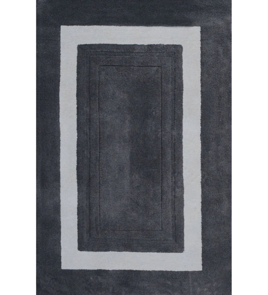 Charcoal grey bordered hand-tufted wool rug with ivory frame